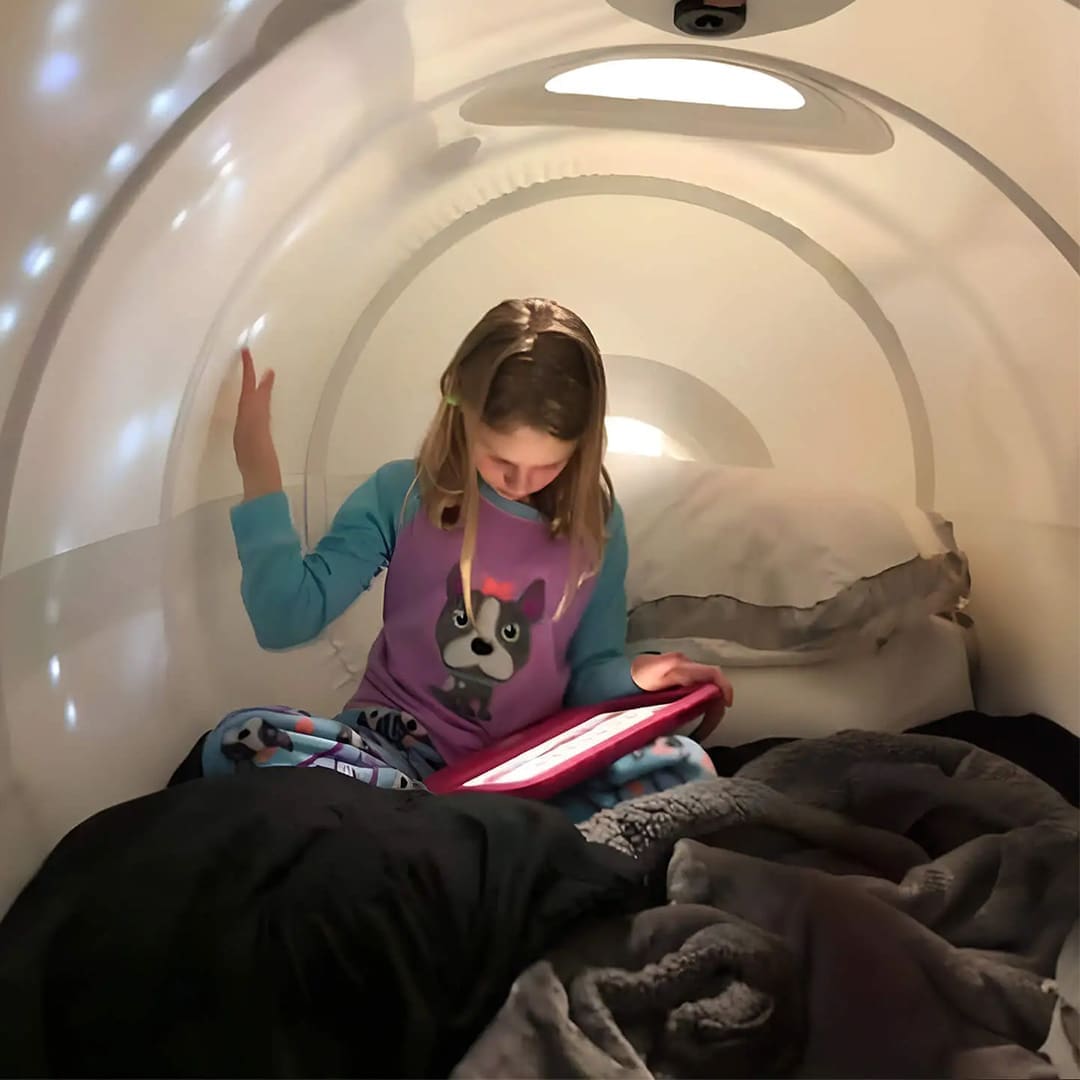 Little girl using her iPad in Hyperbaric Oxygen Chamber